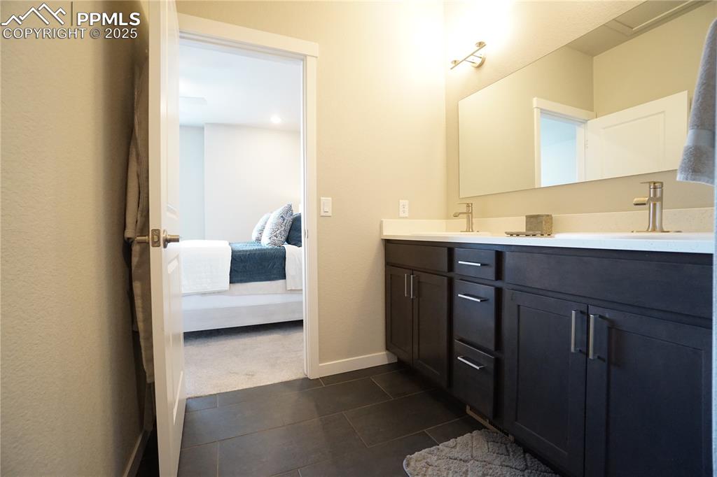 5309 Passport View Colorado Springs, CO 80922 - Photo 27 of 33 a en suite bathroom with a sink and a mirror