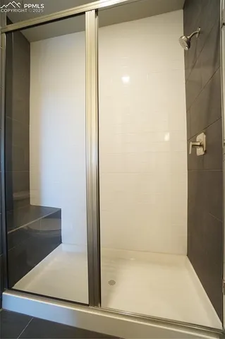 a bathroom with a glass shower door