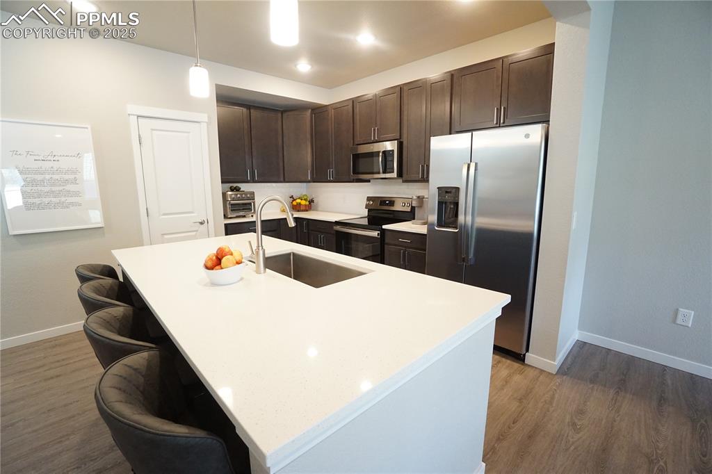 5309 Passport View Colorado Springs, CO 80922 - Photo 7 of 33 a kitchen that has a microwave a sink and a refrigerator