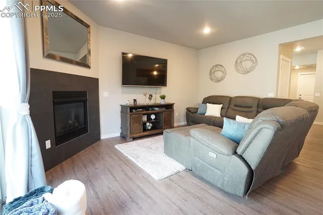 a living room with furniture fireplace and flat screen tv