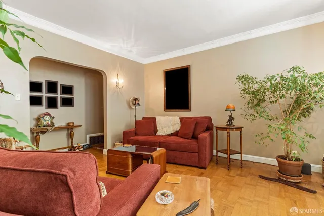 a living room with furniture and a potted plant