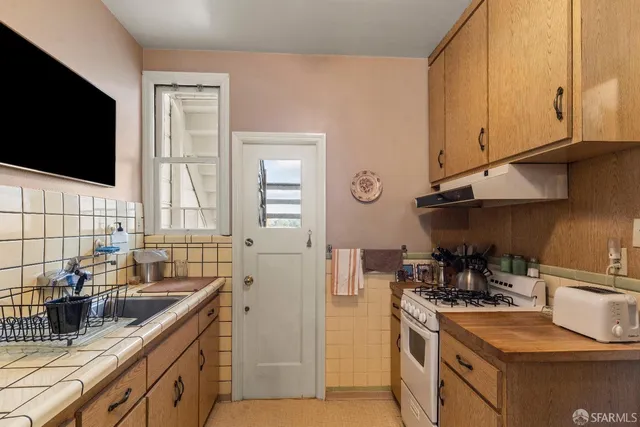 a kitchen with stainless steel appliances granite countertop a sink stove and microwave