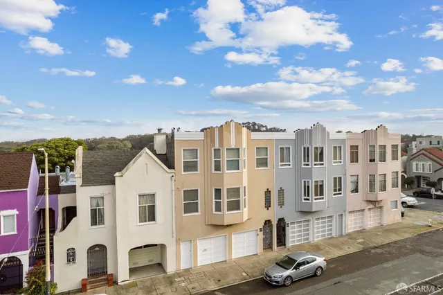 a view of a white building among the street