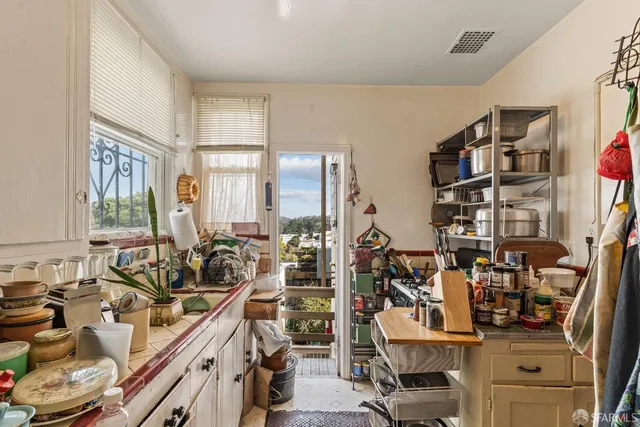 a room with gym equipment and large windows