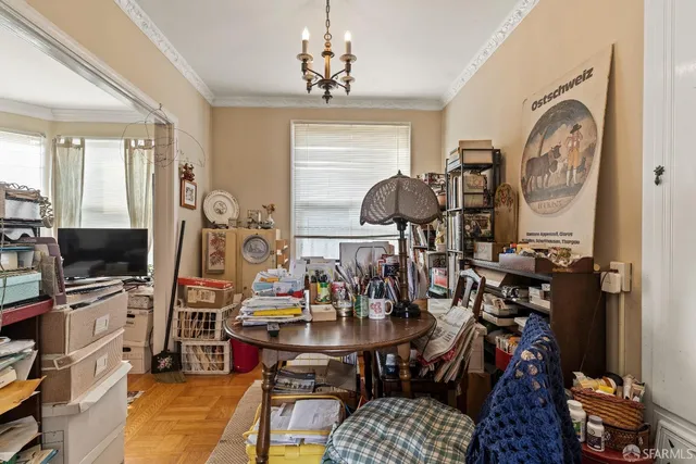 a view of a dining room with furniture and chandelier