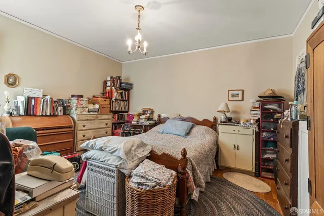 a bed room with a bed and a chandelier