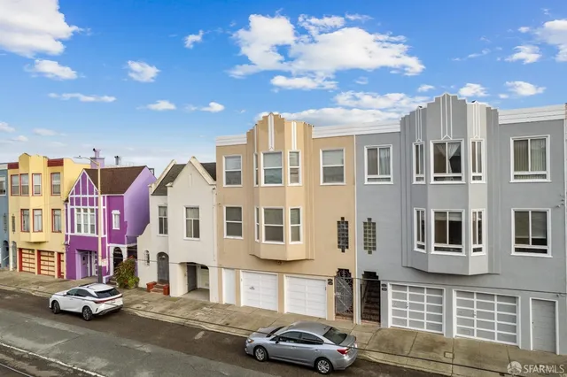 a couple of cars parked in front of a building