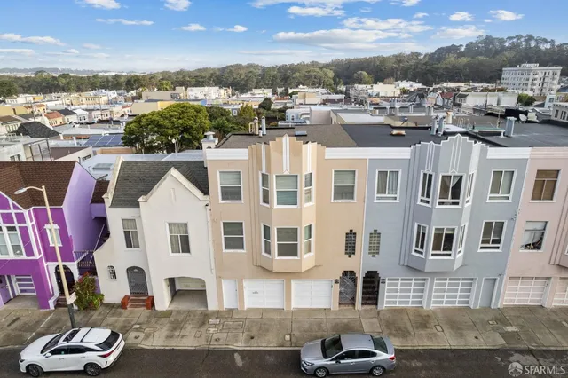 a front view of a residential apartment building with a yard