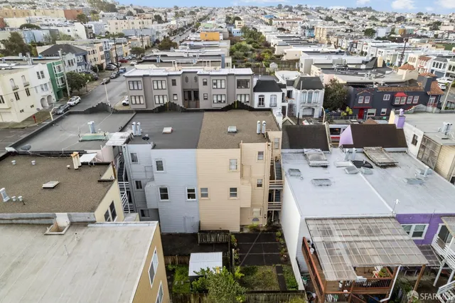 an aerial view of residential houses with outdoor space
