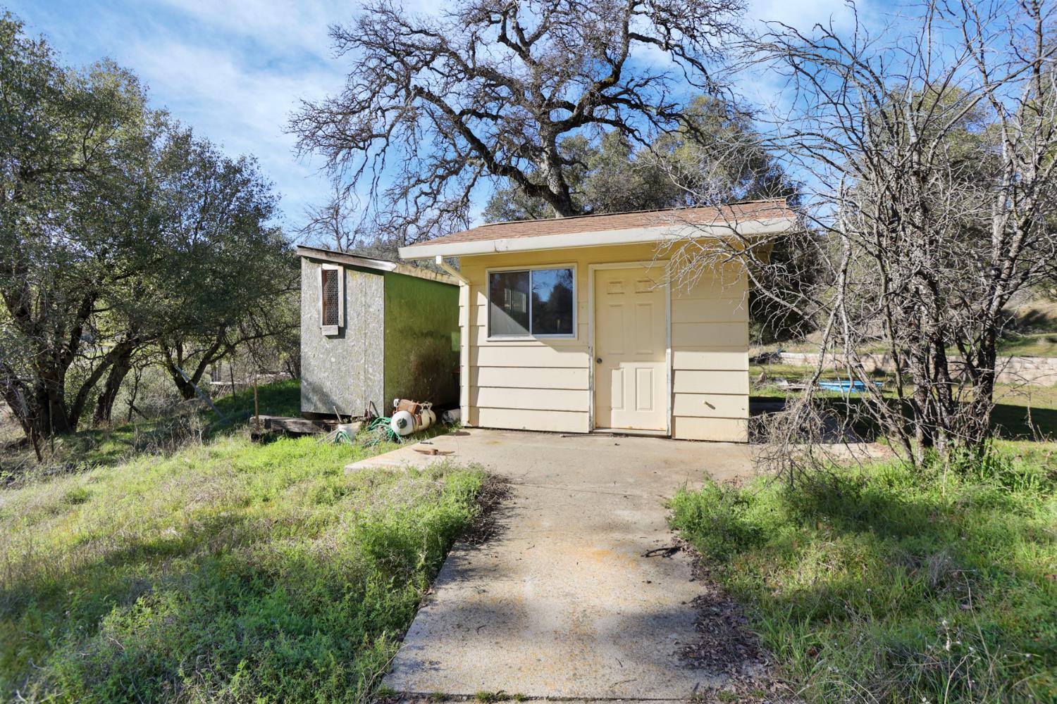 20200 Tuolumne Road North Tuolumne, CA 95379 - Photo 11 of 43 a front view of a house with a yard and garage