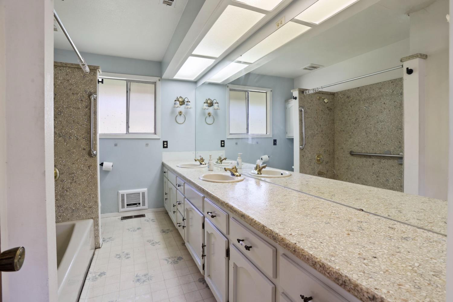 20200 Tuolumne Road North Tuolumne, CA 95379 - Photo 21 of 43 a spacious bathroom with a granite countertop sink mirror and a shower