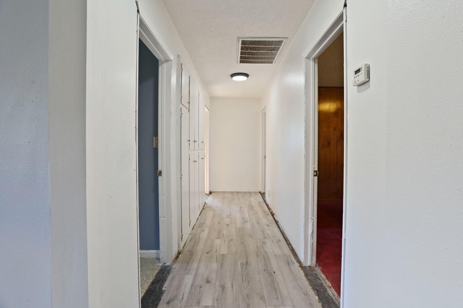 20200 Tuolumne Road North Tuolumne, CA 95379 - Photo 23 of 43 a view of a hallway with wooden floor