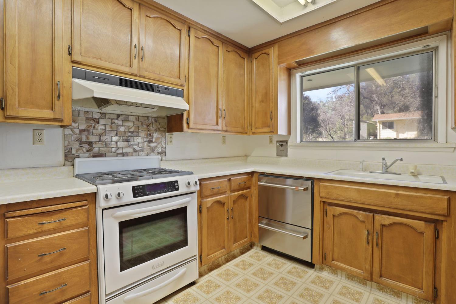 20200 Tuolumne Road North Tuolumne, CA 95379 - Photo 34 of 43 a kitchen with cabinets appliances and a window