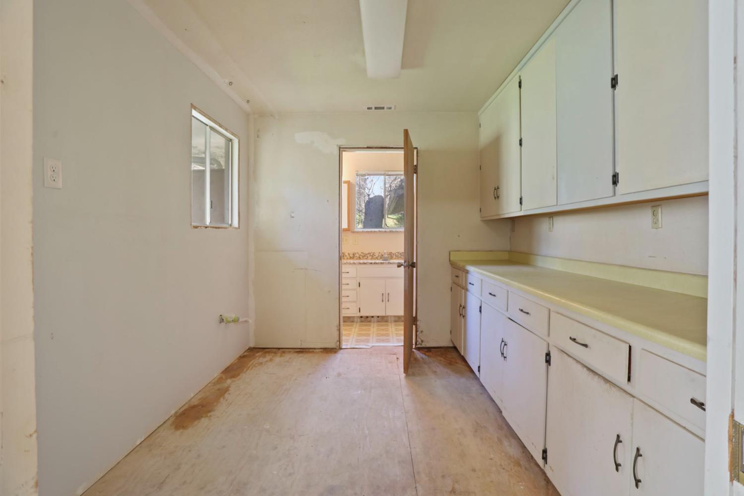 20200 Tuolumne Road North Tuolumne, CA 95379 - Photo 40 of 43 a kitchen with granite countertop white cabinets and stainless steel appliances