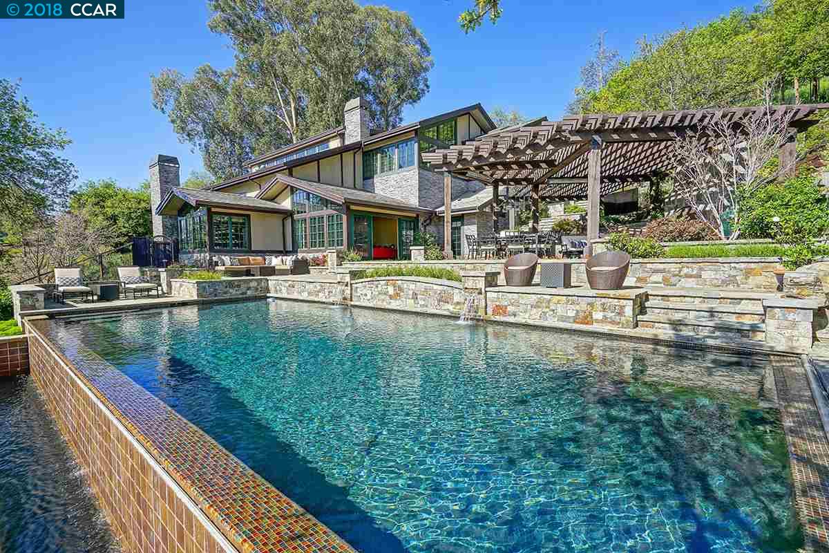 a view of a house with pool and chairs