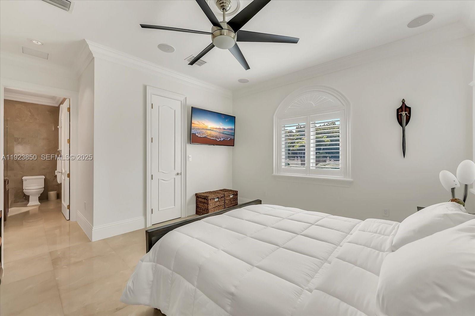 18611 Southwest 122nd Street Miami, FL 33196 - Photo 15 of 55 a bedroom with a bed and a view of bathroom