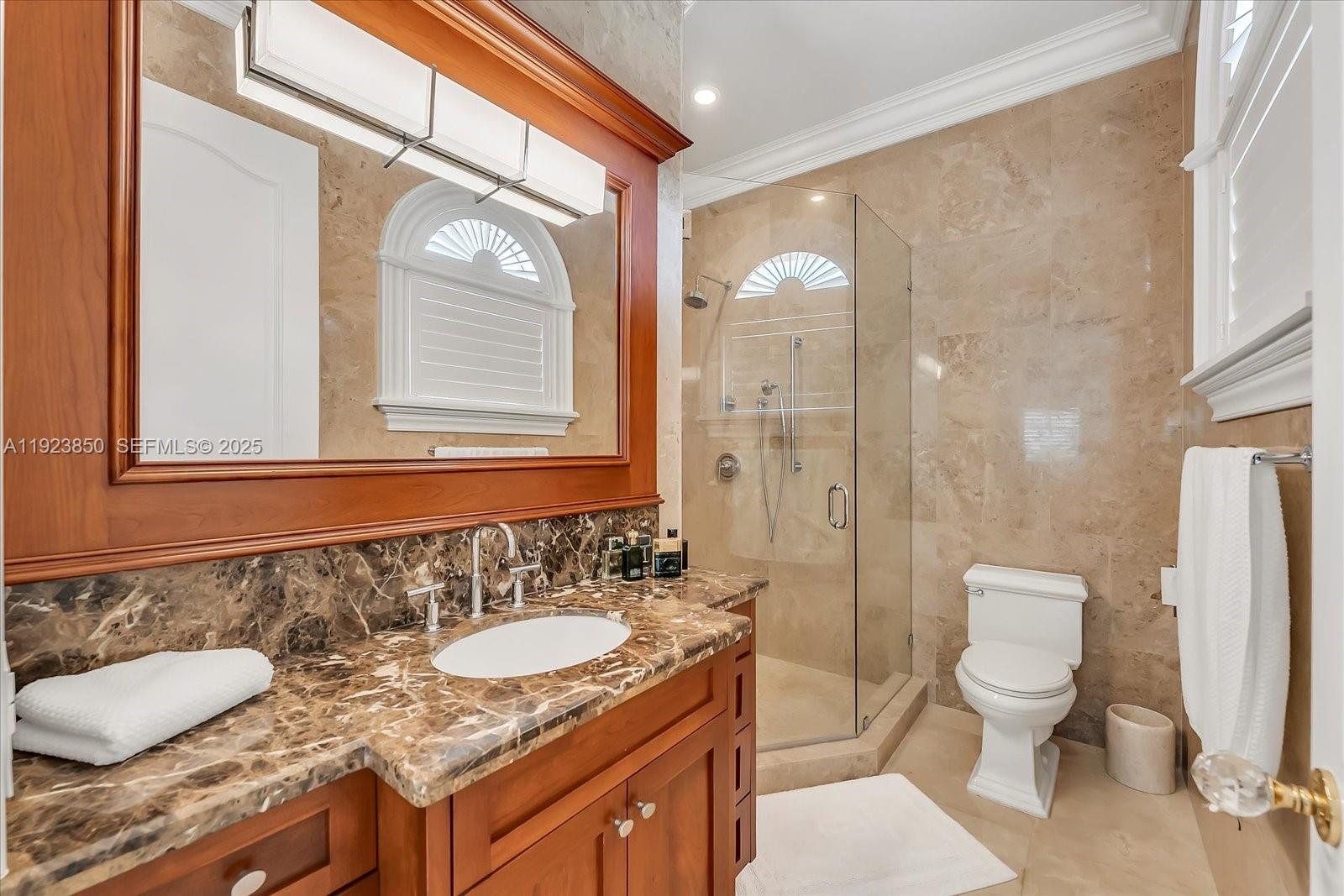 18611 Southwest 122nd Street Miami, FL 33196 - Photo 16 of 55 a bathroom with a granite countertop sink a toilet and a shower