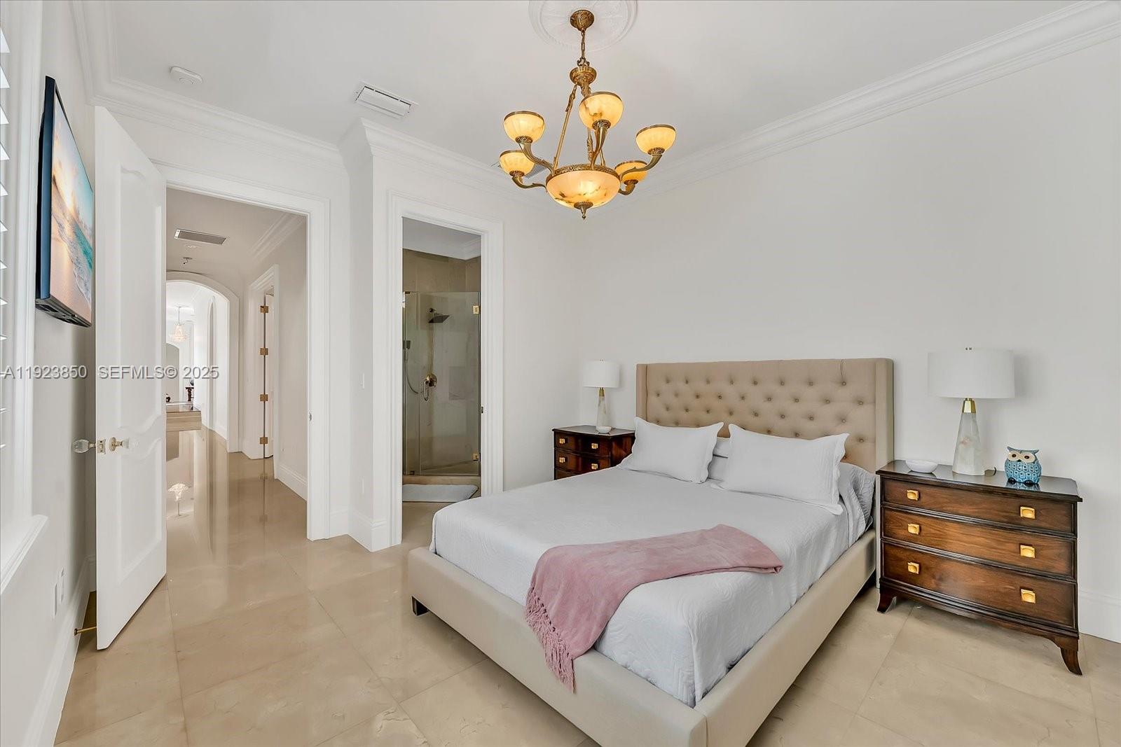 18611 Southwest 122nd Street Miami, FL 33196 - Photo 32 of 55 a bedroom with a bed and a chandelier