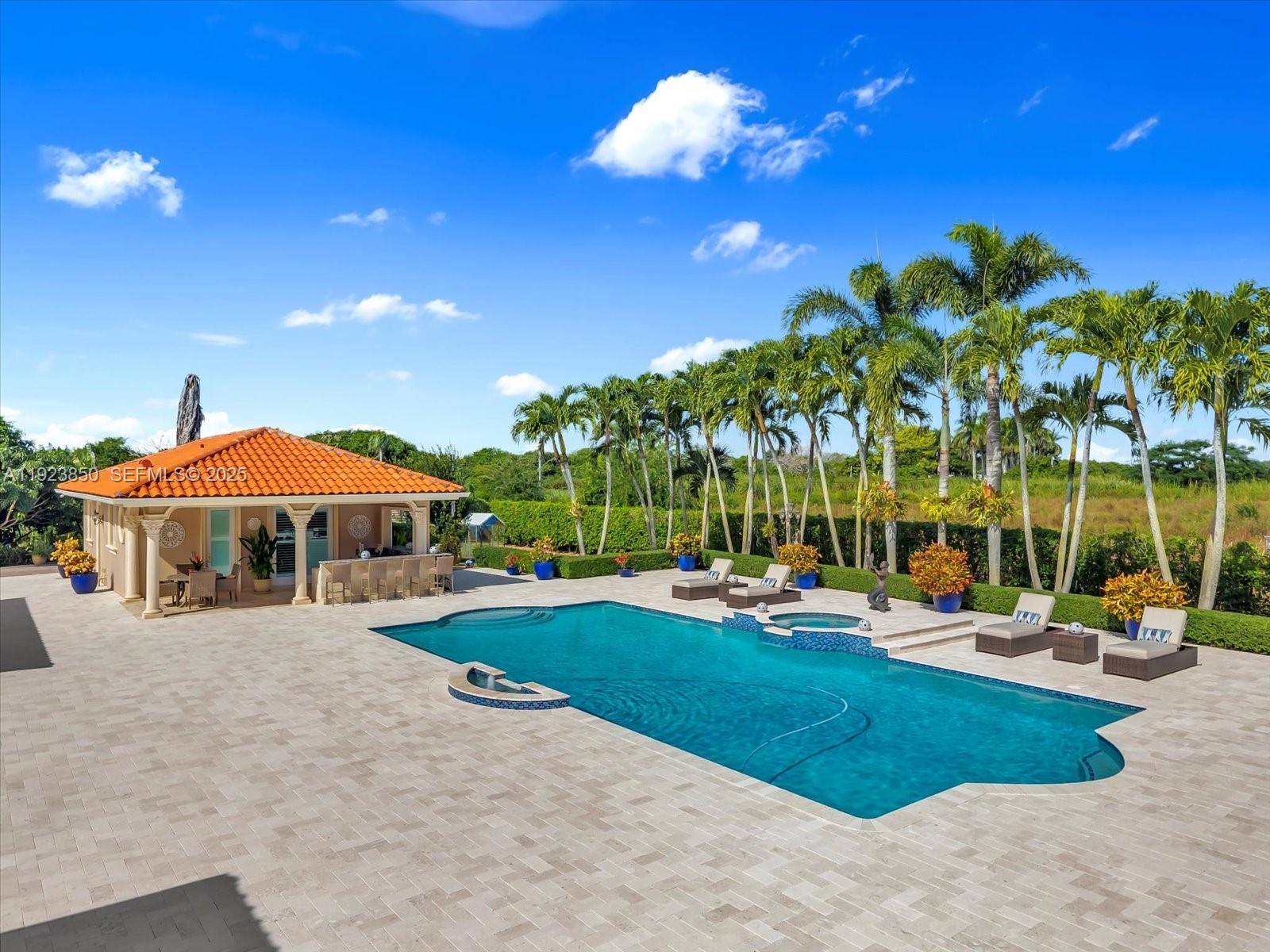 18611 Southwest 122nd Street Miami, FL 33196 - Photo 44 of 55 a view of a swimming pool with lounge chairs