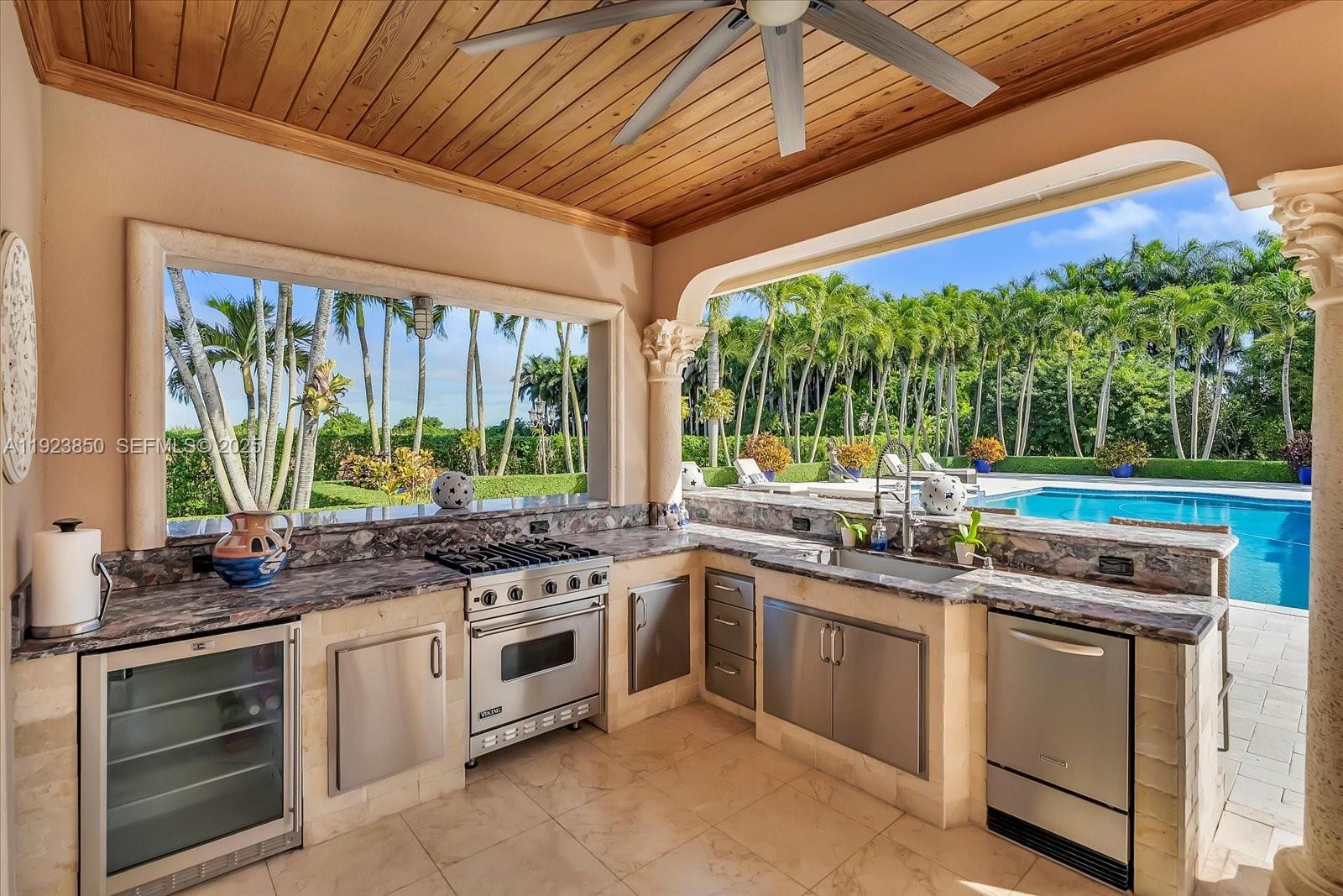 18611 Southwest 122nd Street Miami, FL 33196 - Photo 47 of 55 a kitchen with stainless steel appliances a stove a sink and a oven