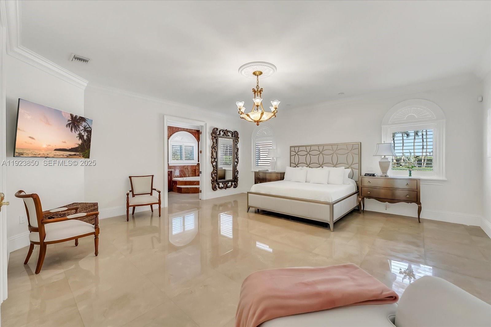 18611 Southwest 122nd Street Miami, FL 33196 - Photo 7 of 55 a bedroom with furniture and a chandelier