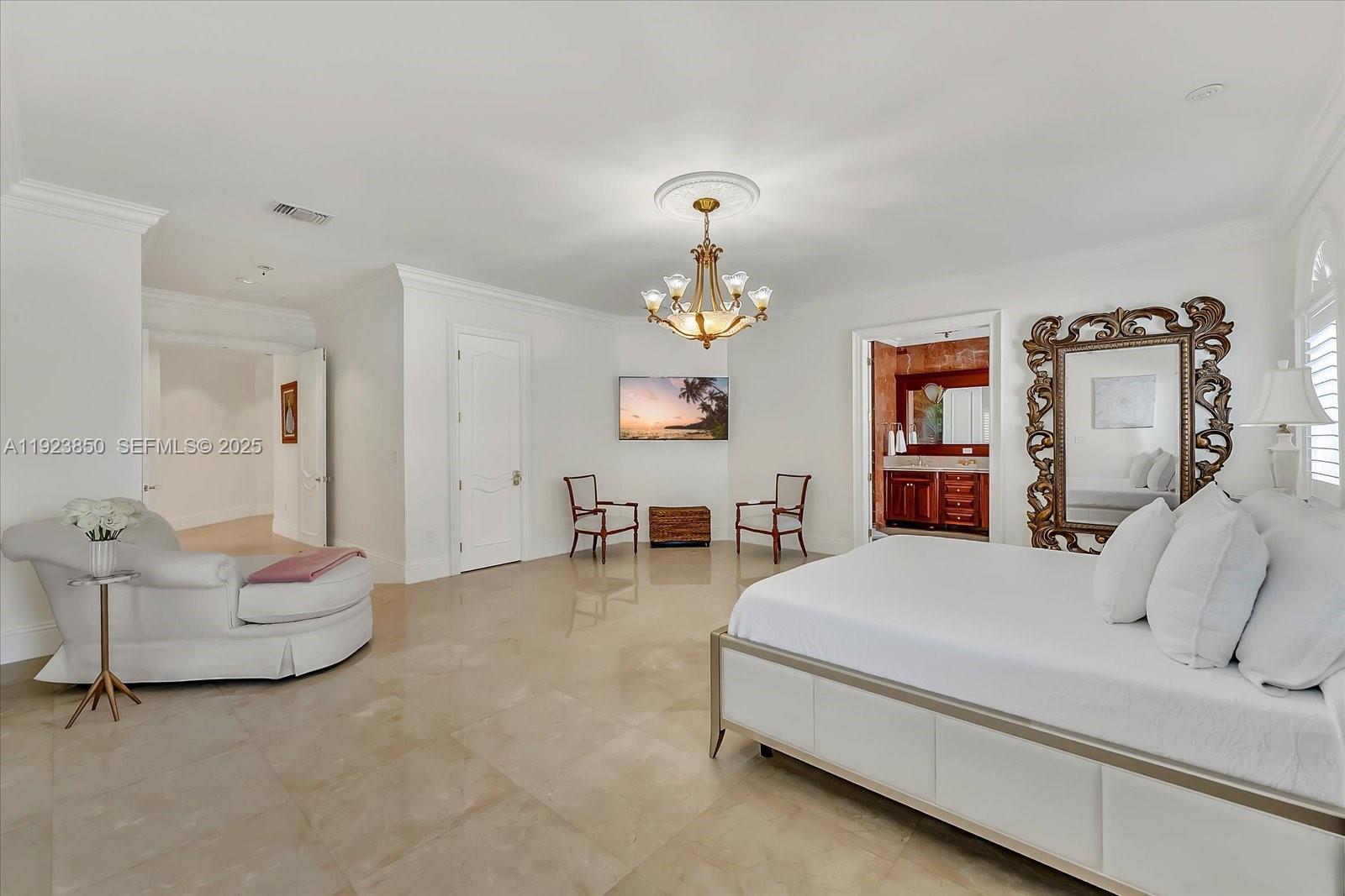 18611 Southwest 122nd Street Miami, FL 33196 - Photo 9 of 55 a spacious bedroom with a bed and a chandelier