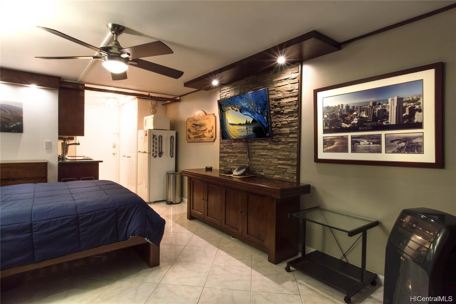 a spacious bedroom with a bed and cabinet