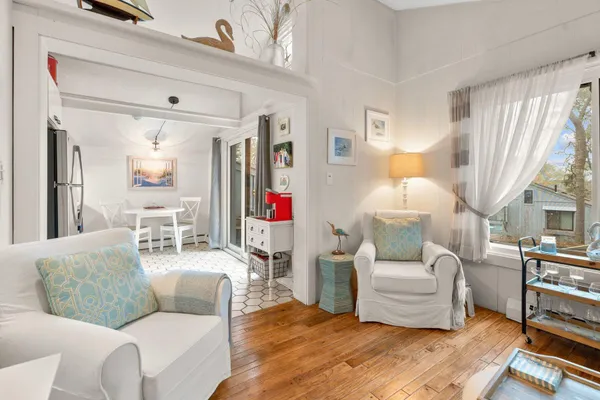 a living room with furniture and a large mirror