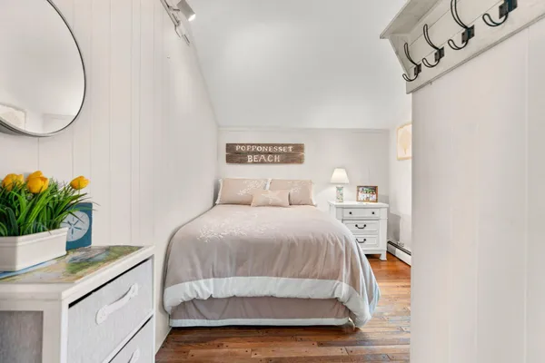 a bedroom with a bed and a potted plant