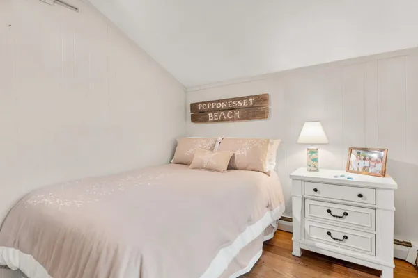 a bedroom with a bed and a night stand