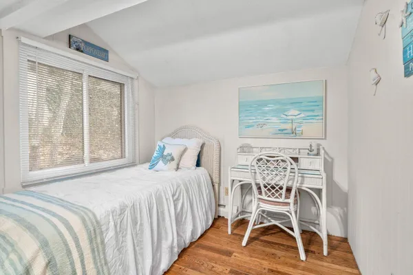 a bedroom with a bed and a table with chair