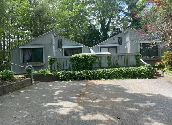 a front view of a house with a yard and a garage