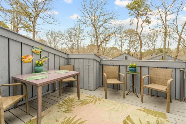 a view of a patio with chairs and table