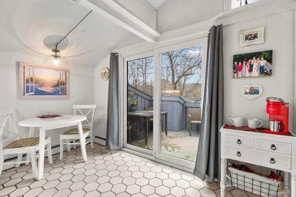 a dining room with furniture and window