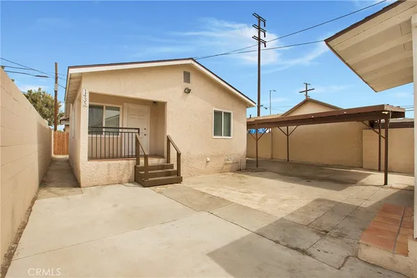 a view of a house with a wooden fence