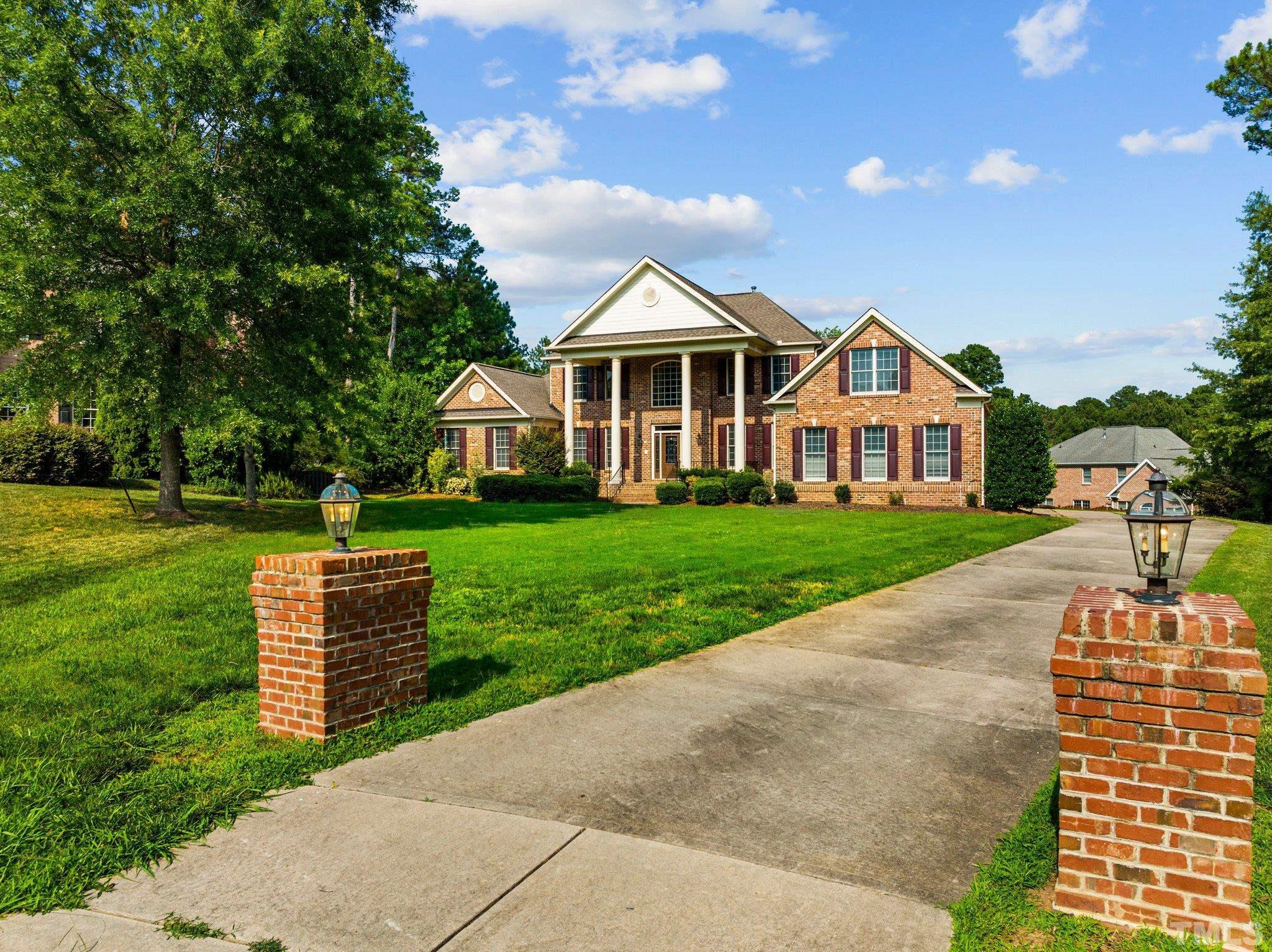 9501 Bluemont Court Raleigh, NC 27617 - Photo 2 of 85 a front view of a house with a garden