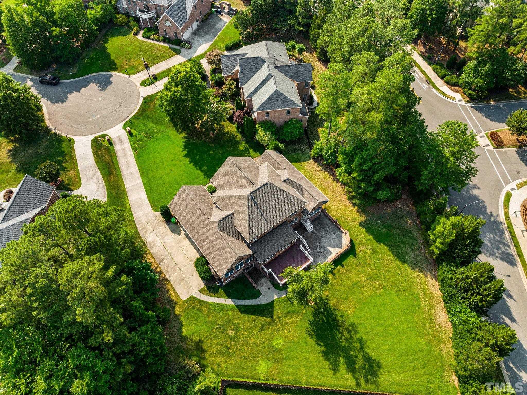 9501 Bluemont Court Raleigh, NC 27617 - Photo 22 of 85 an aerial view of a house with a garden and swimming pool