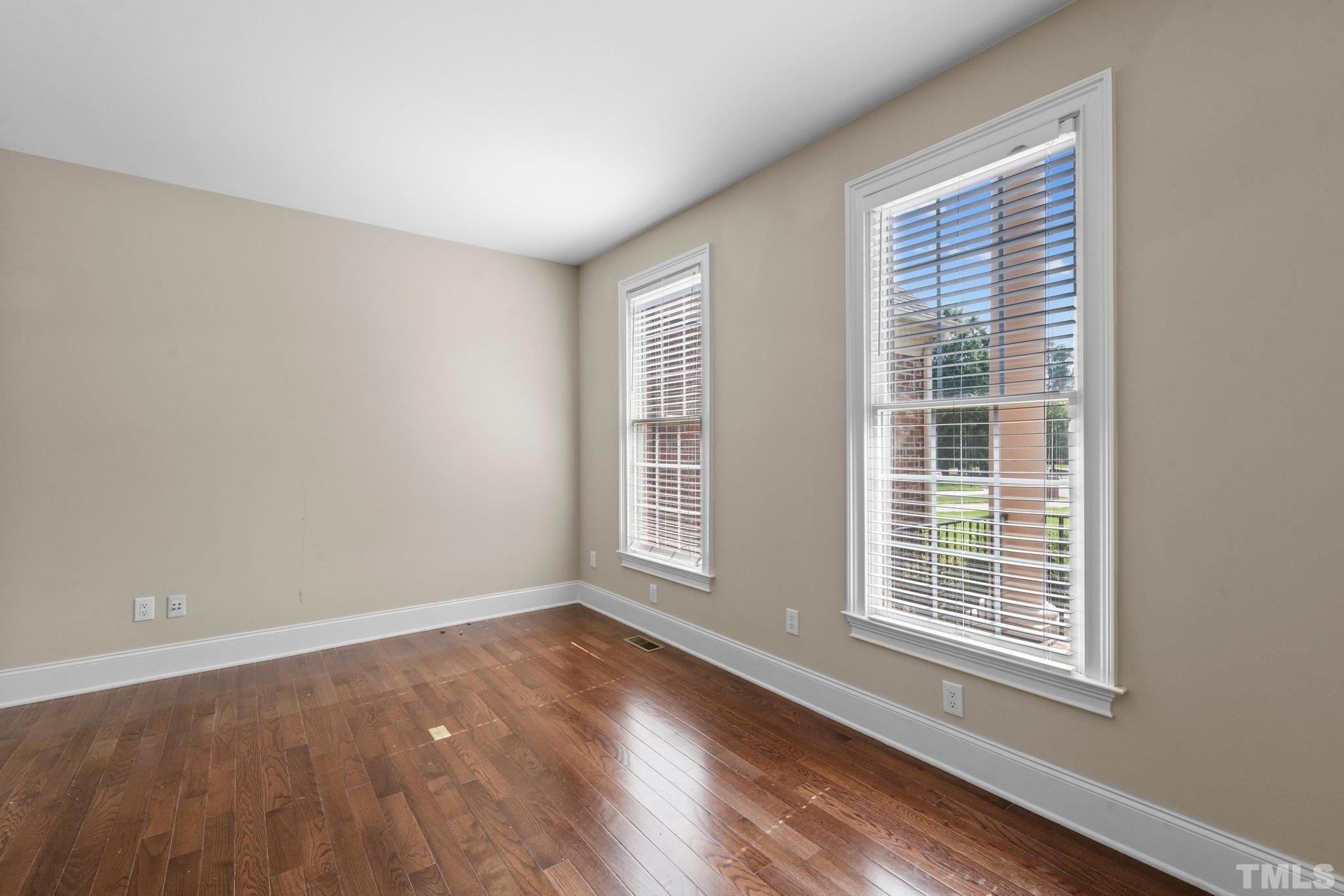 9501 Bluemont Court Raleigh, NC 27617 - Photo 33 of 85 a view of an empty room with wooden floor and a window