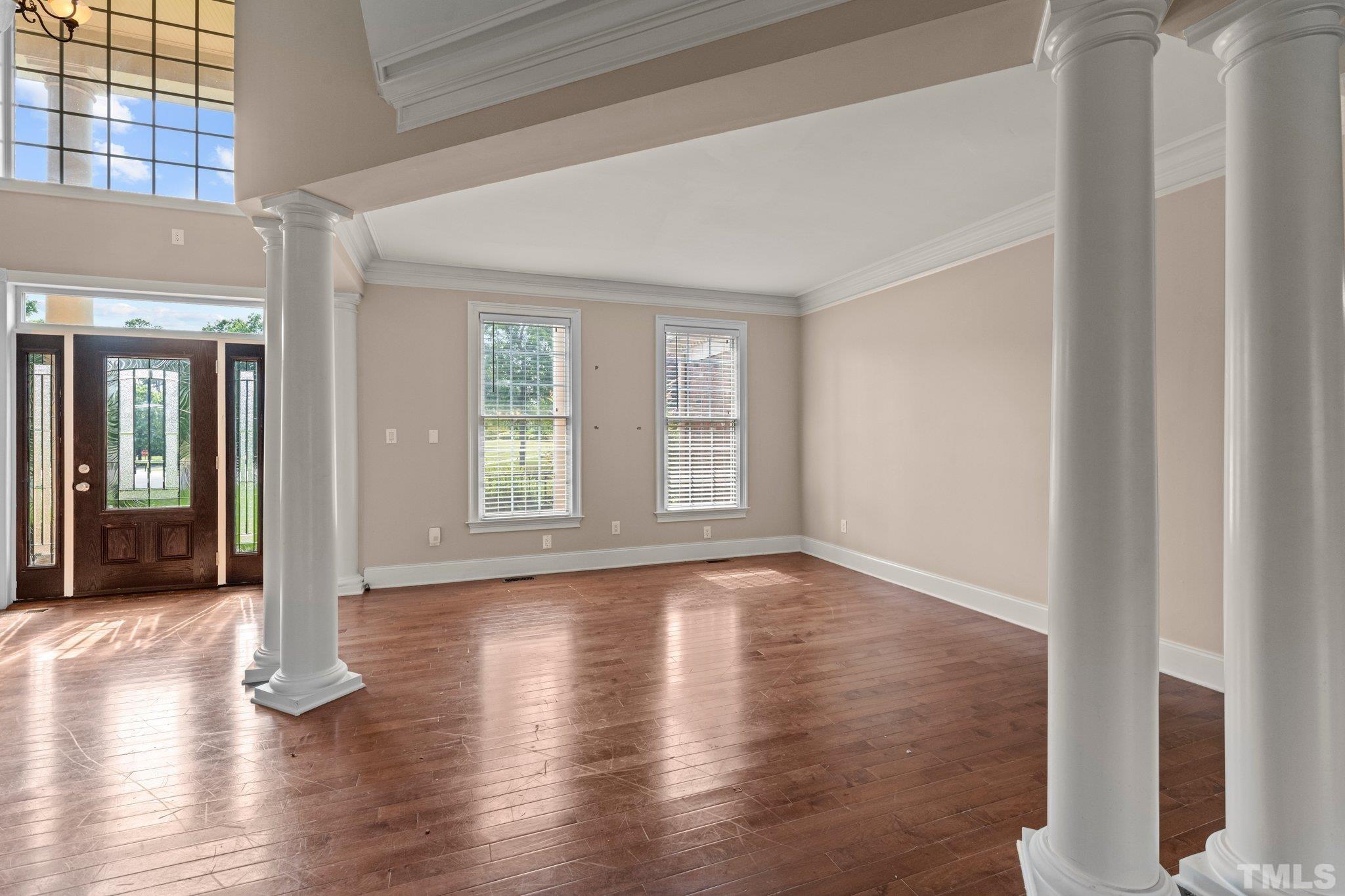 9501 Bluemont Court Raleigh, NC 27617 - Photo 36 of 85 a view of an empty room with wooden floor and a window