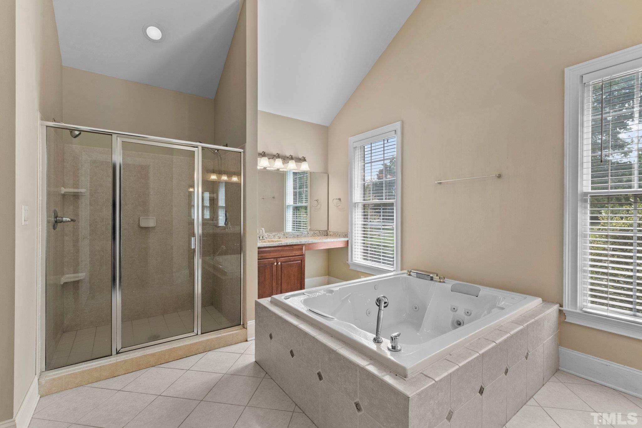 9501 Bluemont Court Raleigh, NC 27617 - Photo 42 of 85 a bathroom with a tub a sink and a shower
