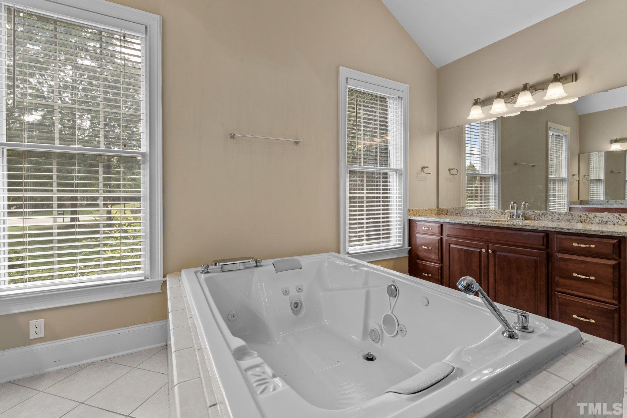 9501 Bluemont Court Raleigh, NC 27617 - Photo 43 of 85 a bath tub sitting in a bathroom next to a window