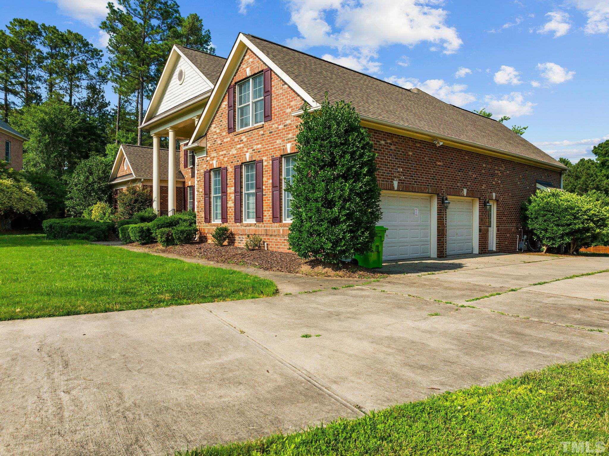 9501 Bluemont Court Raleigh, NC 27617 - Photo 5 of 85 a front view of a house with a yard and garage