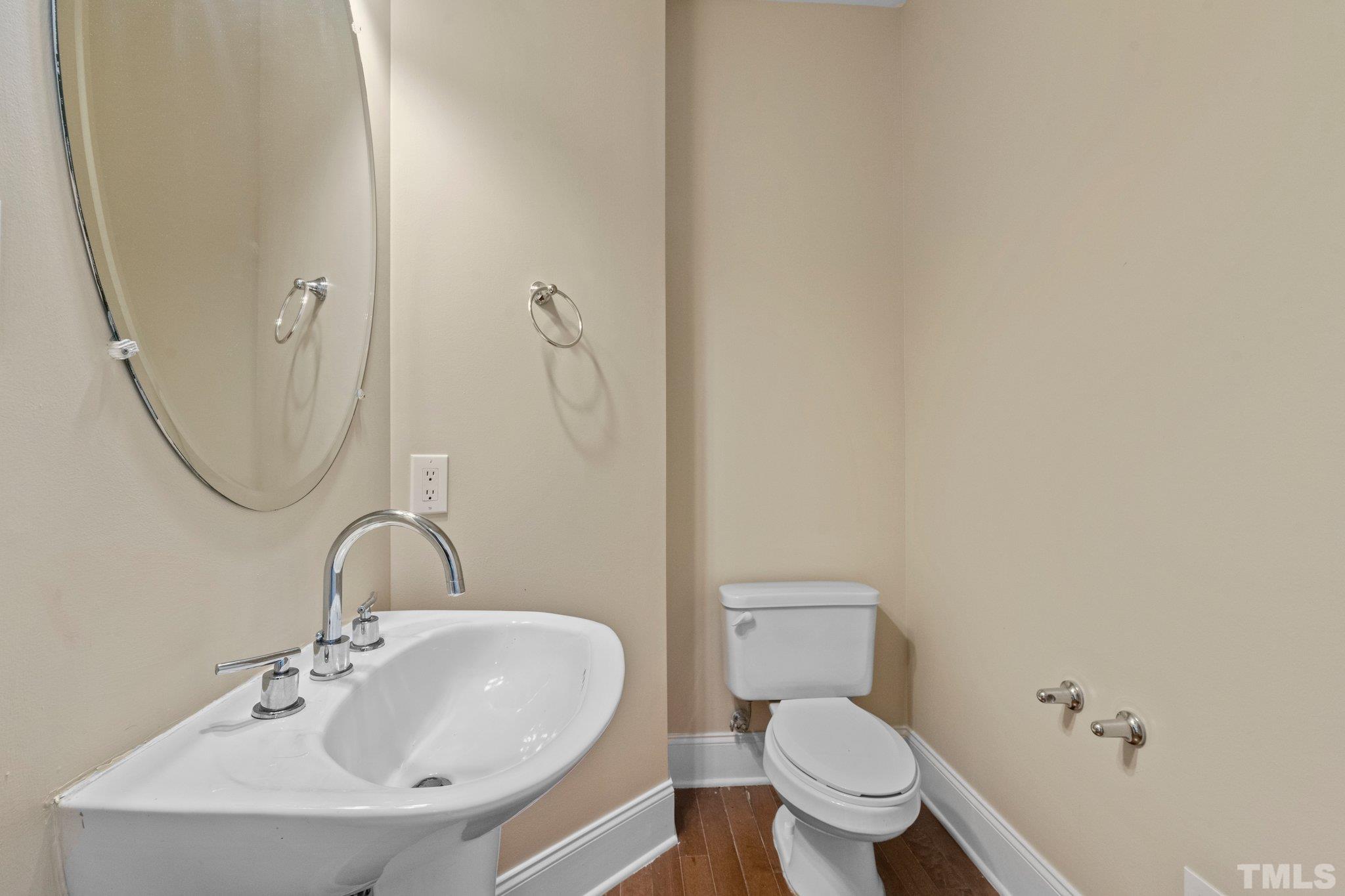 9501 Bluemont Court Raleigh, NC 27617 - Photo 56 of 85 a bathroom with a toilet a sink and mirror