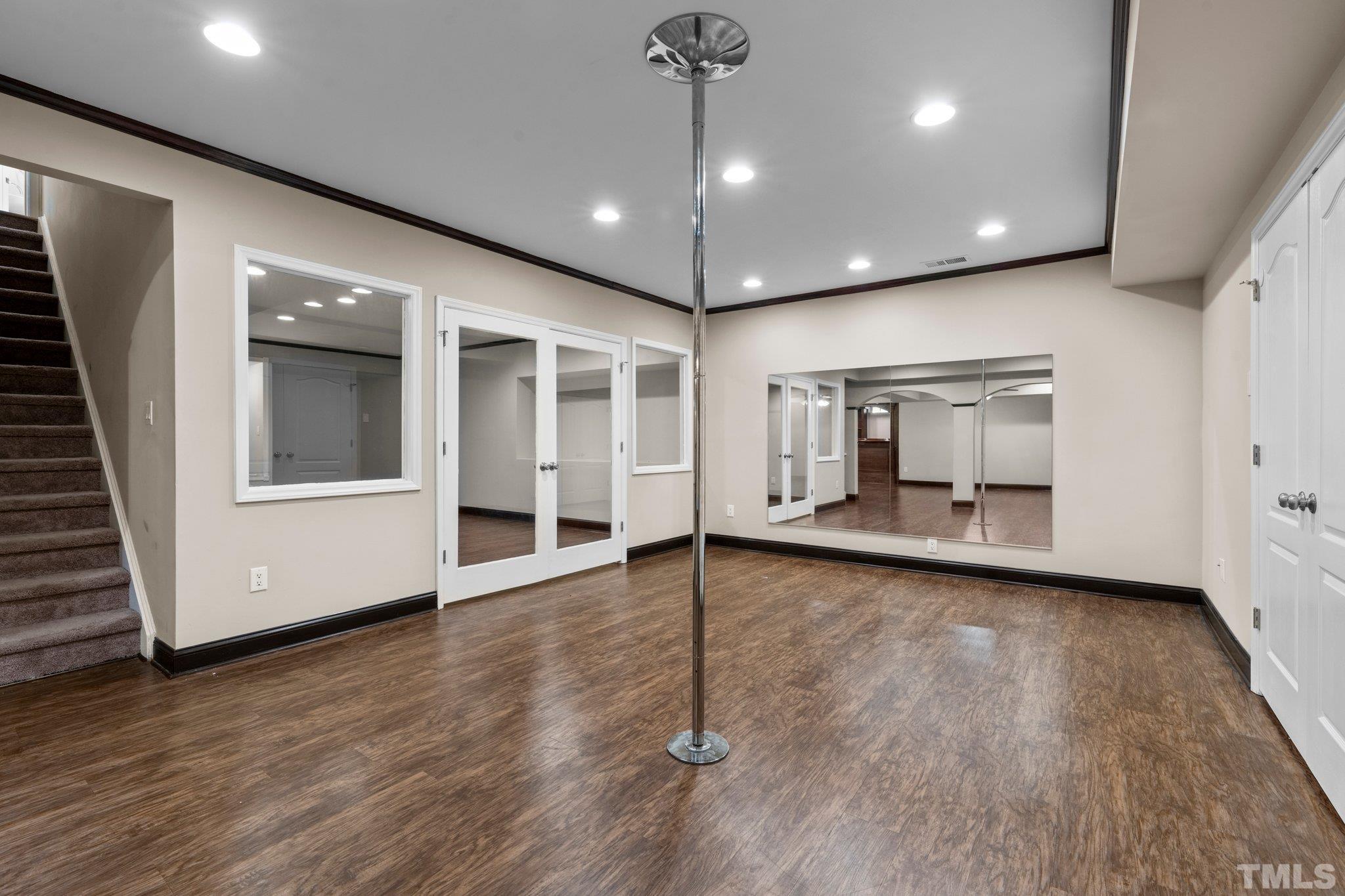 9501 Bluemont Court Raleigh, NC 27617 - Photo 60 of 85 a view of a big room with wooden floor chandelier and windows