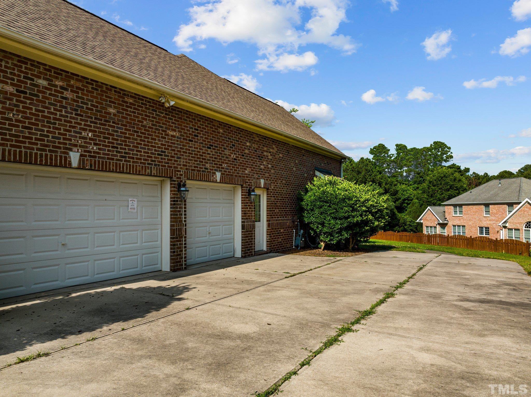 9501 Bluemont Court Raleigh, NC 27617 - Photo 6 of 85 a front view of a house with a yard and garage