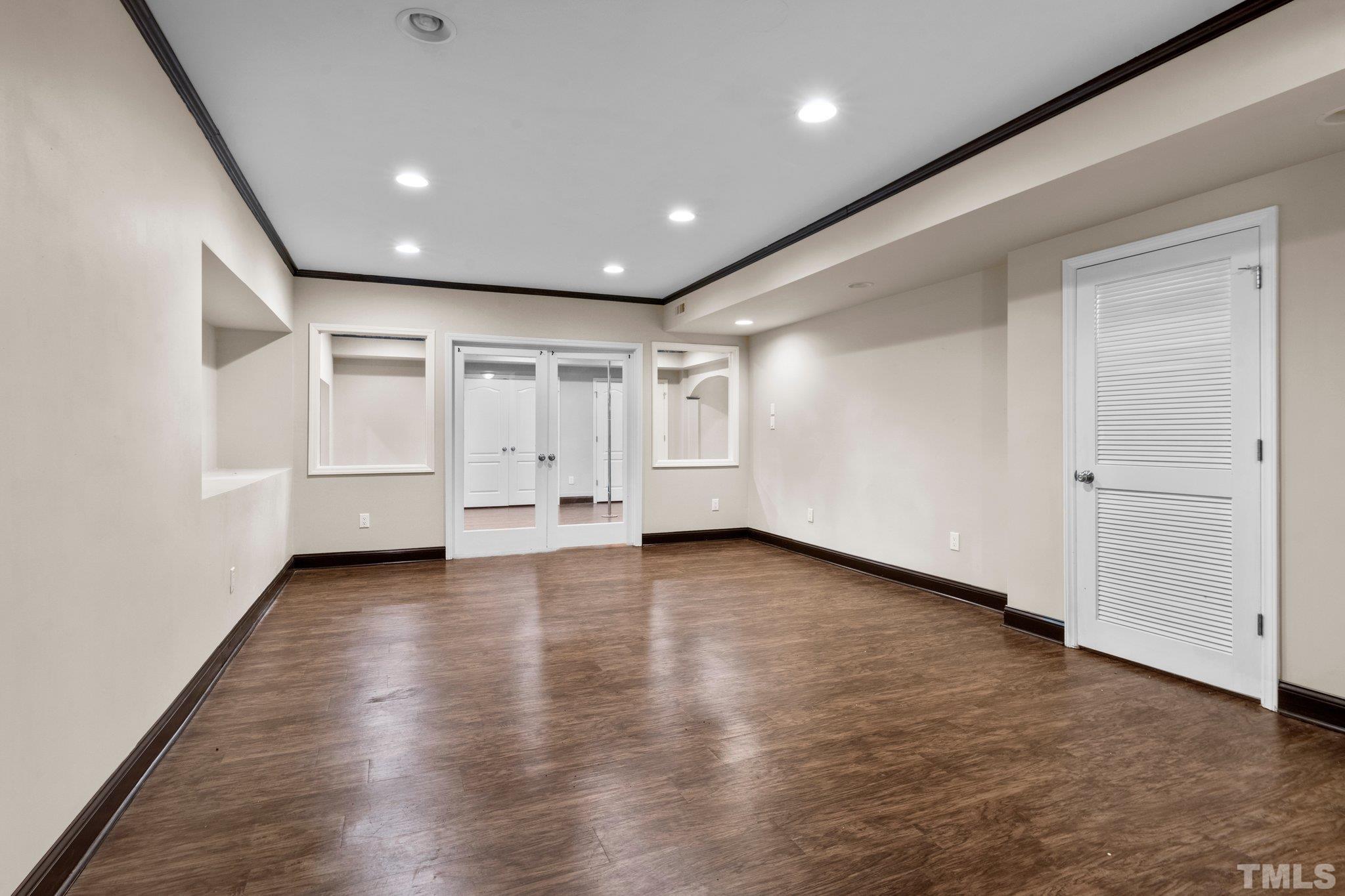 9501 Bluemont Court Raleigh, NC 27617 - Photo 69 of 85 an empty room with wooden floor and white walls