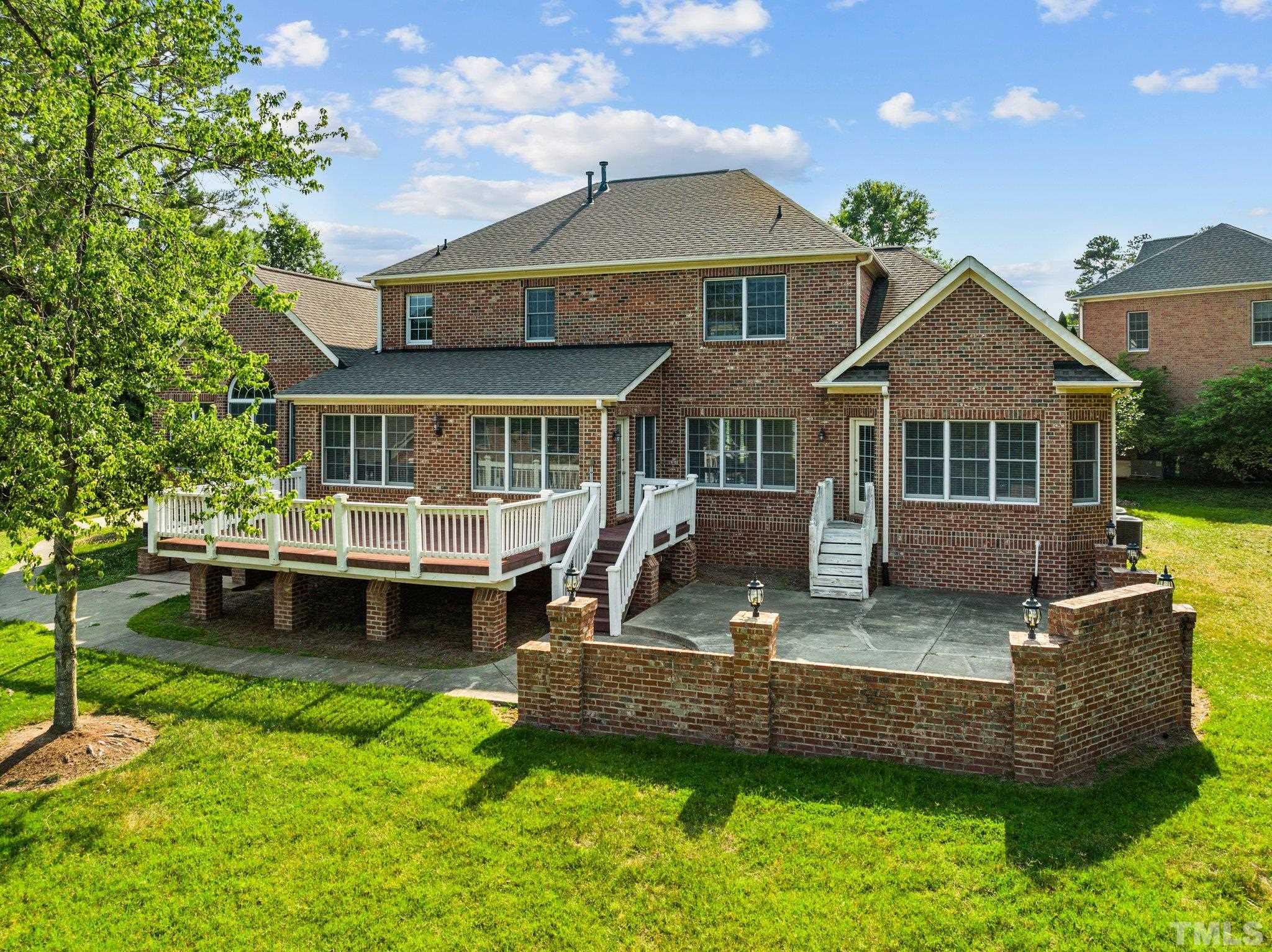 9501 Bluemont Court Raleigh, NC 27617 - Photo 10 of 85 a front view of a house with a yard table and chairs