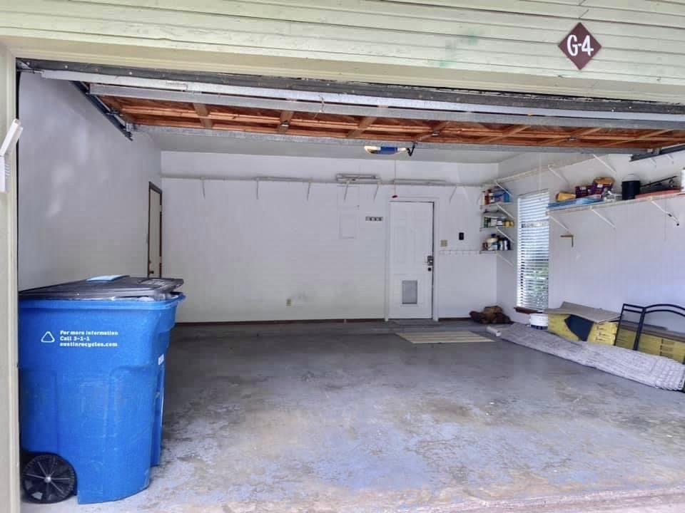 4404 Travis Country Circle, Unit G4 Austin, TX 78735 - Photo 10 of 15 A well-maintained garage offers ample space for vehicles and storage solutions.