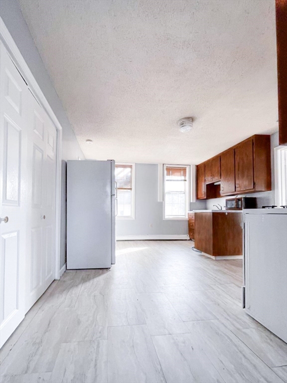42 Mammoth Road Lowell, MA 01854 - Photo 6 of 15 a view of a kitchen with wooden floor