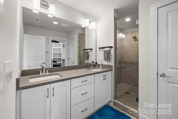 a bathroom with a granite countertop sink mirror and double